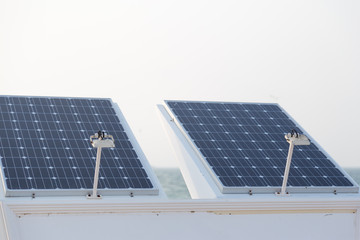Photovoltaic panel on top of shower standing on the beach