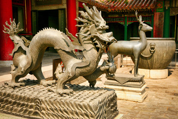 Fototapeta na wymiar Bronze statues of the dragon and deer in the Forbidden City. Beijing, China