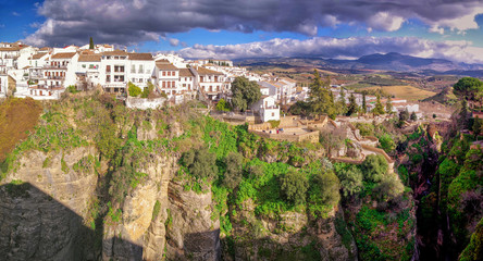 Fototapeta na wymiar Ronda city panorama and canyon view. Panoramic view of town of Ronda, one of the famous villages in Andalucia, Malaga, Spain.