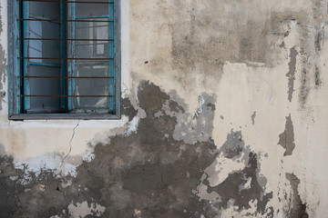 Broken Old Window and a Peeling Wall