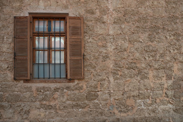 Fototapeta na wymiar Old Brown Window and a Brick Wall