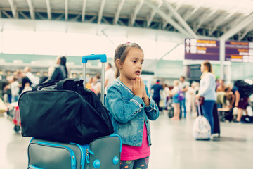 Little girl with suitcase travel in the airport, kids travel