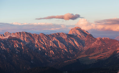 Great dolomite mountains with trees below in daily sunlight