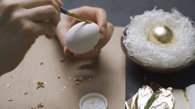 Decoration of Easter eggs with gold foil