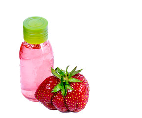 strawberry, ripe berries and cosmetic bottle with pink contents..