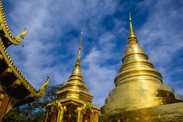 Naklejka premium Wat Phra Singh, Chiang Mai, Thailand, The golden pagoda and blue sky on 5 January 2019