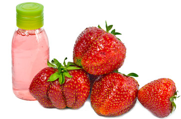 strawberry, ripe berries and cosmetic bottle with pink contents..