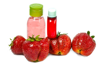 strawberry, ripe berries and cosmetic bottles .
