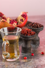 Different varieties of Shisha Smoking hookah. Black annealed ceramic bowl for hookah in the background of tea cups and the open pomegranate.