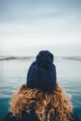 Rear view of female head with red curly hair
