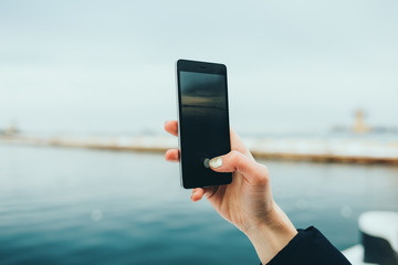 Close-up of female hand holding mobile phone