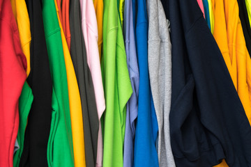 colorful t-shirts for sale at an outdoor market