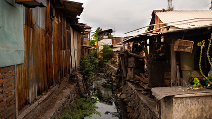 Poor area with slums and sewers in Indonesia. Poor asian city block