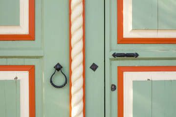 Beautiful wooden door with a round metal handle. door knocker with a ring. background texture