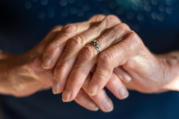 Elderly old woman's hands together