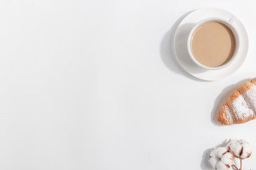 A cup of coffee with milk on a light background. Top view. Copy space.