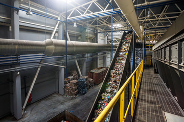 moving conveyor transporter on Modern waste recycling processing plant. Separate and sorting garbage collection. Recycling and storage of waste for further disposal.