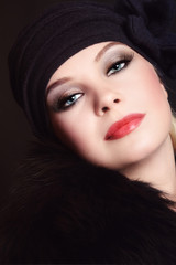 Vintage style portrait of young beautiful woman with smoky eye make-up and false eyelashes
