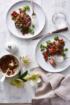 Grilled Filet Mignon with Red Pepper and Cilantro on 2 plates