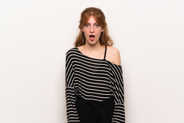 Young redhead woman over white wall with surprise and shocked facial expression