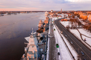 Riga, Latvia. January 10, 2019. Many warships docked at the port in the icy river. Aerial view of...
