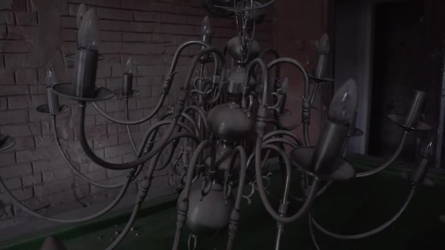 fallen down chandelier on pool billiards table in old abandoned mansion stately home