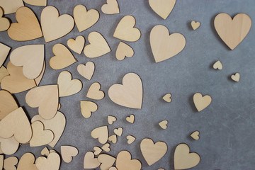 A lot of wooden  decorative hearts on gray background. Valentine's Day Concept.