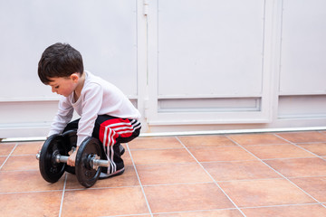 Child playing with weights at home