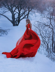 fair-haired lady does not show her face in the photo, dressed in gorgeous amazing red wonderful...