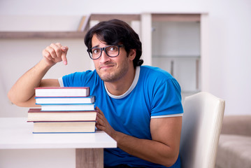 Young handsome student studying at home 