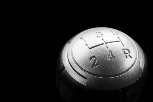 Close up view of a gear lever shift isolated on black background. Manual gearbox. Car interior details. Car transmission. Soft lighting. Abstract view. Car detailing