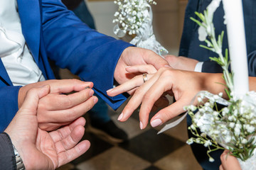 Traditional wedding ceremony in orthodox church, golden wedding rings exchange. Close up.