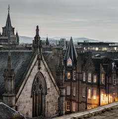 View of Edinburgh's old medieval town architecture from a roof top with street light on. Scotland, UK. Travel. Atmospheric. Gothic