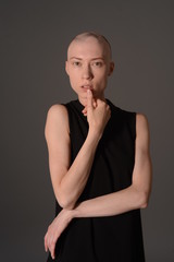 bald girl posing in Studio in black dress