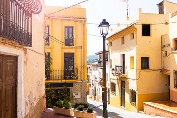 Fototapeta na wymiar Cozy street of the old European city Polop. Mediterranean architecture in Spain