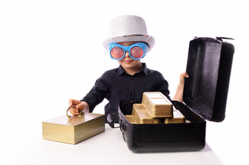 A little boy, 5 years old, plays with gold bars. He works in the bank as a security guard. The...