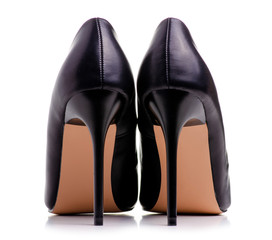 Female black leather high heels shoes on white background isolation