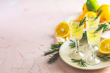 Liqueur limoncello with pieces of lemon and rosemary herb