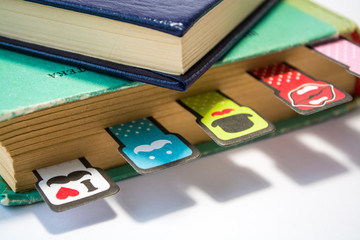 Old books on a white background. Cheerful and amusing bookmarks with moustaches of different coloring. Home library.
