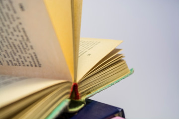 Old books on a white background. the turned yellow old pages. Home library.