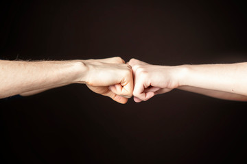 Fist bump or Knuckle bump between two friends f