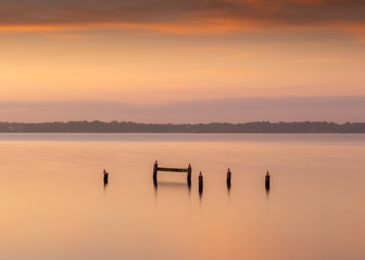 View on the broken pier in the lake at sunrise