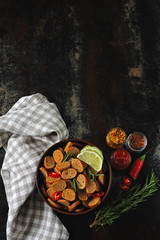 Small rye crackers in a bowl with spices. Croutons with rosemary, chili and lime. Vegan snack