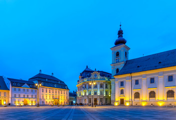 Fototapeta na wymiar The Big Square with the Citty Hall in Sibiu at sunrise in Transylvania region, Romania