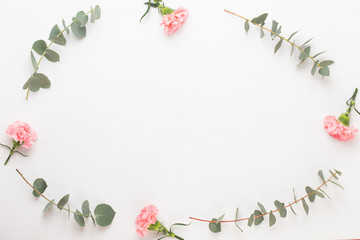 Flowers and eucaaliptus composition. Pattern made of various colorful flowers on white background. Flat lay stiil life.