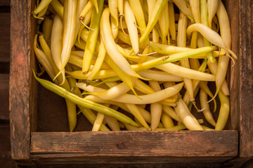 Fresh yellow beans in a old wooden box