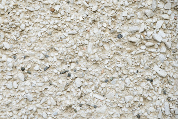 concrete wall covered with stone crumbs