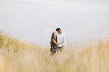 A couple photo  hugging and waling on nature in meadow , looking to each other