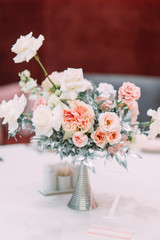 Decor, wedding tables in the restaurant. Floristry, arch and flowers in the design.
