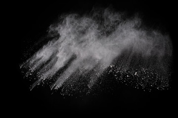 White powder explosion on black background. Colored cloud. Colorful dust explode. Paint Holi.